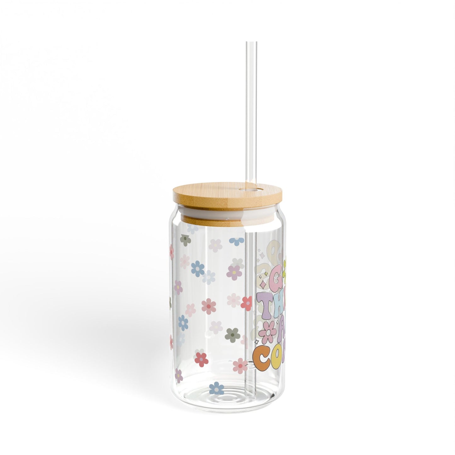 Clear tumbler with colorful designs, wooden lid, and straw on a white background