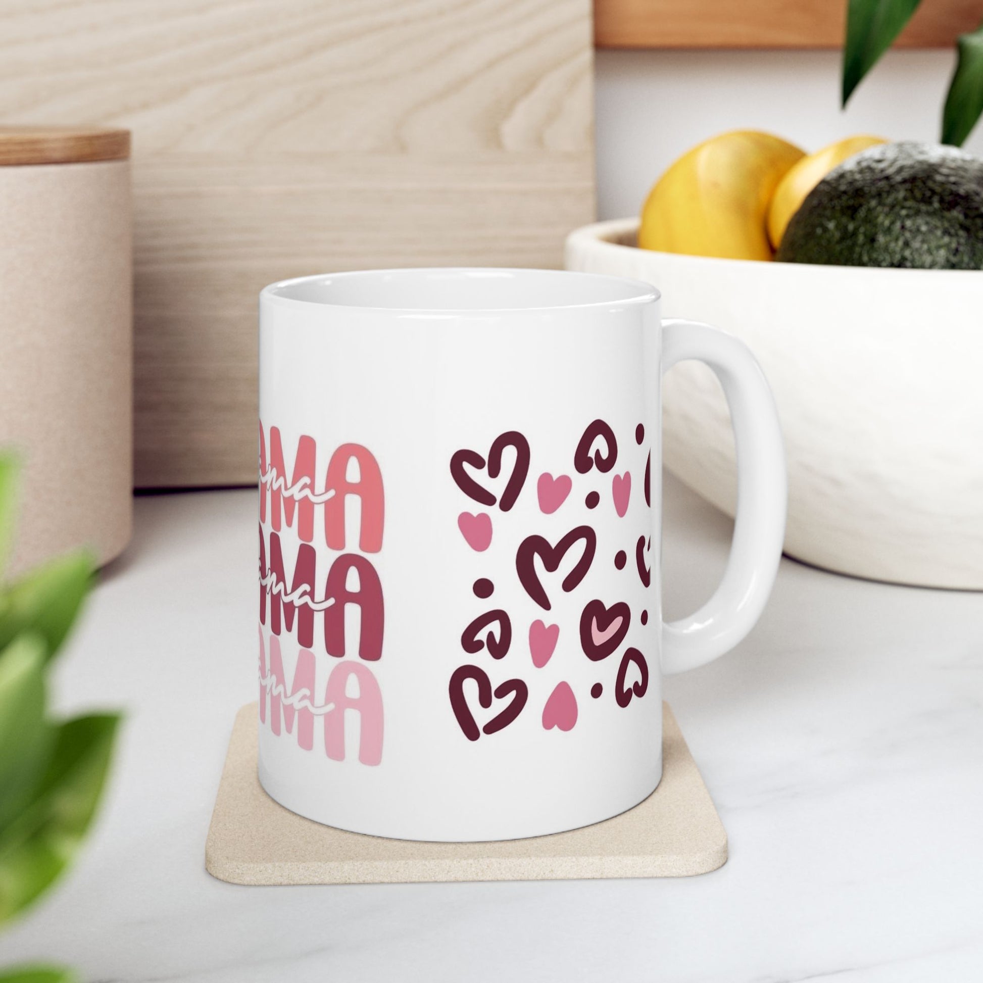 White ceramic mug with multiple pink ‘Mama’ text prints