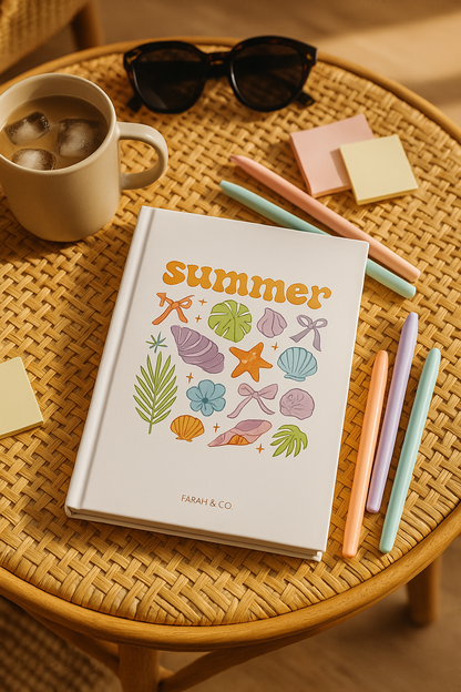 Hardcover white notebook with colorful summer-themed illustrations, including seashells, palm leaves, and bows, labeled “Summer Vibes” on the front.