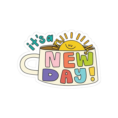 Sticker with a cup design and 'it's a new day!' text on a white background